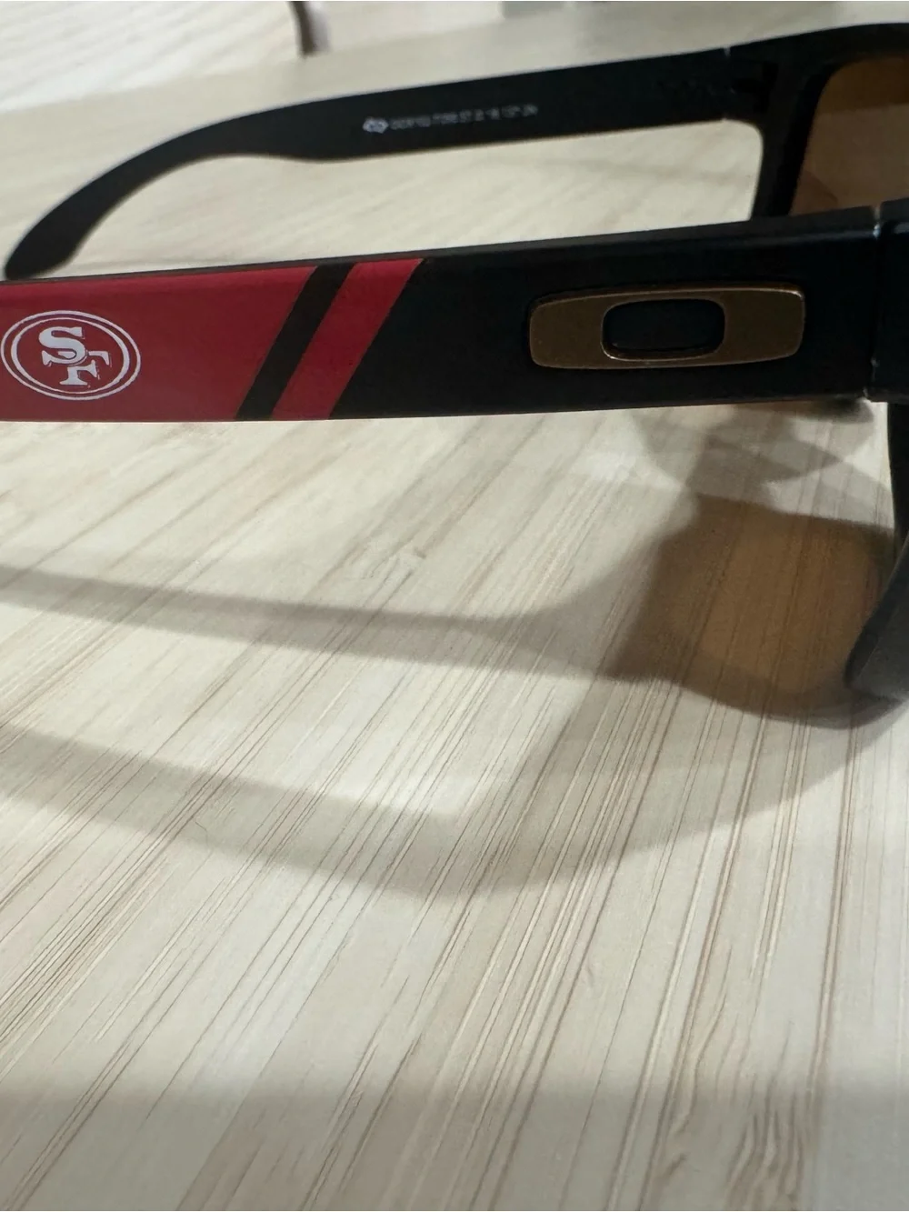 Oakley Black Sunglasses with Red Stripe and Gold Hardware